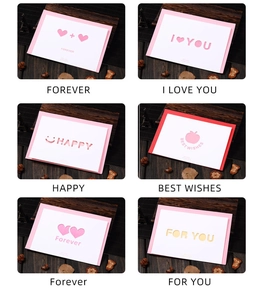 Detailed close-up of hollowed-out heart greeting cards with various romantic English messages