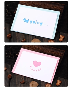 Detail of laser-cut blue and pink greeting cards with puppy and heart hollow designs