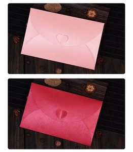 Detailed view of pink and red pearlescent envelopes with creative heart-shaped clasps