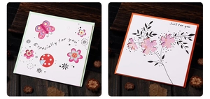 Detail of floral greeting cards with butterfly motifs on a wooden background