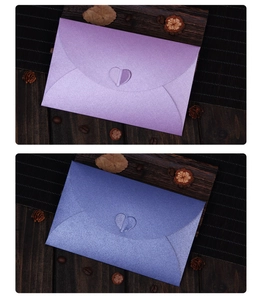 Detailed view of pearlescent envelopes in purple and blue with a heart-shaped closure