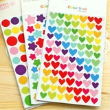 Macro detail of colorful heart, star, and circle sticker sets in clear card packaging