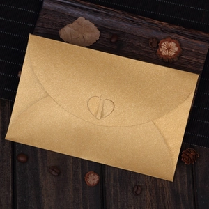 Elegant gold pearlescent card envelope with a unique heart-shaped buckle closure