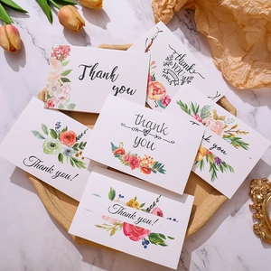 Detailopname van elegante bloemen bedankkaarten met goudfolie op een marmeren achtergrond