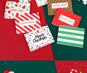 Detail of Christmas cards with gold foil lettering and festive patterns on red and green