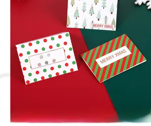 Detail of three festive Christmas card designs with trees and dots on a holiday background