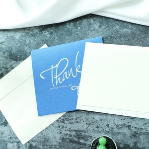 Elegant blue Thank You greeting card with white envelope on a textured background