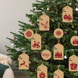 Close-up of buffalo plaid Christmas gift tags hanging on a decorated tree with lights