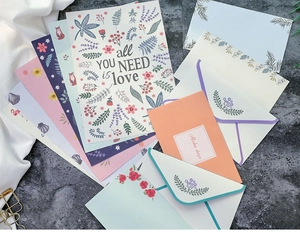Detailed view of floral and animal stationery set on stone texture with silk accents