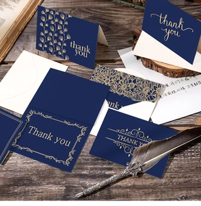 Detailed view of dark blue thank you cards with elegant gold foil mandala stamping and envelope