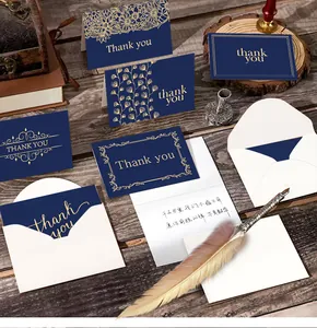Detailed close-up of navy blue gold-foil thank you cards with premium white envelopes