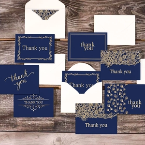 Navy blue gold foil thank you cards set with envelopes on vintage wood background