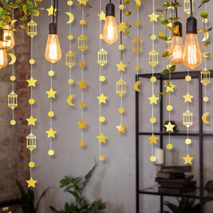 Detail of hanging gold mirror star moon and lantern garland for Eid party decor