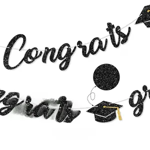Close-up of black glitter Congrats Grad banner with graduation cap and gold tassel