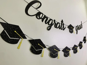 Detail of glitter Congrats Grad banner with black and gold graduation cap patterns