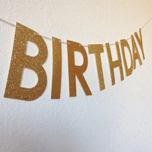 Glittery gold Happy Birthday banner with sparkling bold letters for party decorations