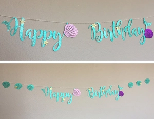Detail of glitter mermaid Happy Birthday banner with teal letters and shell accents
