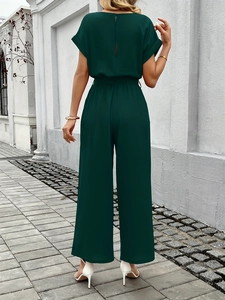 Back view of dark green wide-leg jumpsuit with elastic waist and back neck opening detail