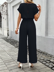Back view of a black short sleeve wide-leg jumpsuit featuring an elegant cutout back design