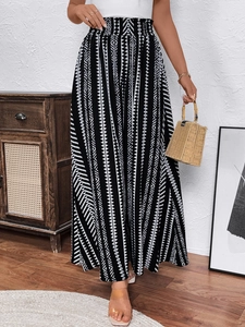 Detail of high waisted elastic smocked waistband on black and white geometric ethnic pants