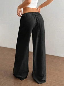Schwarze weite Baumwollhose für Damen mit hohem elastischem Bund und Plissee-Struktur
