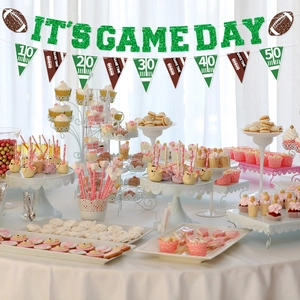 Green glittery IT'S GAME DAY banner and football pennants for sports party decoration