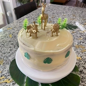 Golden jungle animal cake toppers with lion, giraffe, and elephant for party decor