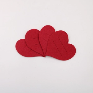 Detail view of 4 red felt hearts with slots for cutlery and wedding table settings