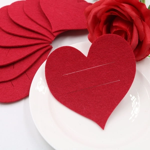 Close-up of red felt heart cutlery holder with dual slits for Valentine's table decor