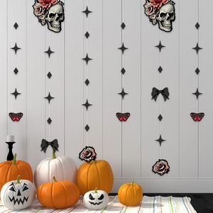 Halloween skull garland set with roses and stars hanging over pumpkin decor