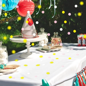 Colorful party hat with strawberry pattern and sun confetti decorations for kids