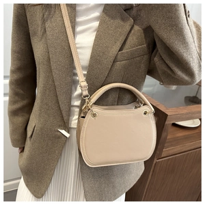 Chic apricot shoulder bag with golden hardware shown with an elegant autumn outfit