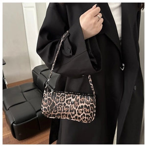 Close-up of leopard print shoulder bag with sleek silver zipper and faux leather texture