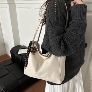 Minimalist beige oversized faux leather tote bag with long shoulder straps for women