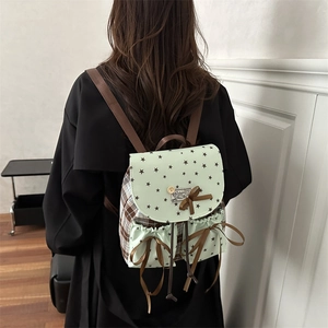 Mint green star print backpack with brown plaid accents and decorative bows for women