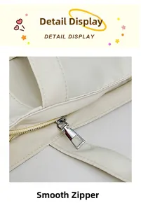 Nahaufnahme eines glatten Reißverschlusses und feiner Nähte an einer cremefarbenen Tasche