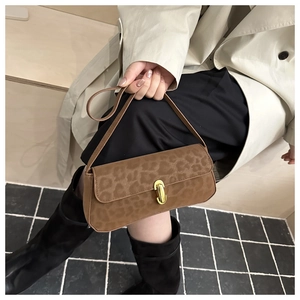 Detail of leopard print crossbody bag featuring premium gold twist lock and matte texture