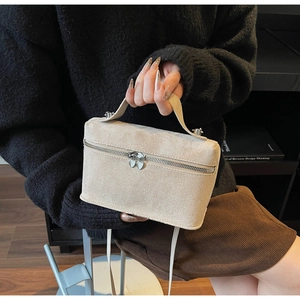 Detail der beigen Wildledertasche mit Herz-Reißverschlüssen und Schultergurt