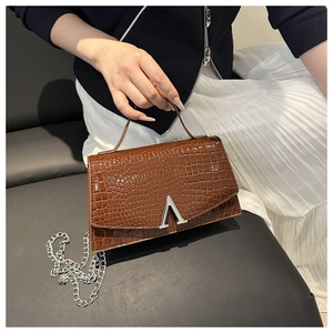 Detailed view of the dark brown croc-embossed leather bag with silver metal A-logo buckle
