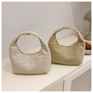 Détail de sacs hobo en paille tressée beige et kaki avec motifs ondulés