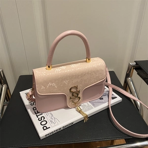 Chic pink and beige snakeskin flap crossbody bag with gold S logo and tassel detail