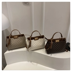 Three vintage tote bags with geometric patterns and gold twist locks on white display