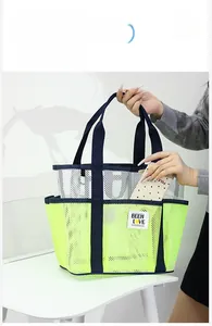 Detail of neon green mesh beach tote featuring multiple outer storage pockets for phones
