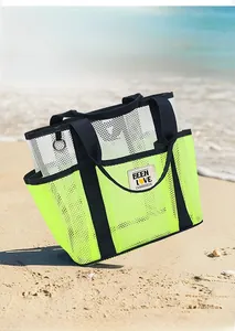 Close-up of neon green mesh beach tote with multi-pocket storage and black straps