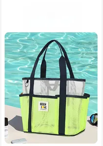 Detail of a neon green mesh beach tote bag with a brand tag next to a swimming pool