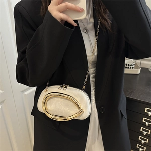 Minimalist beige crossbody bag with gold chain strap and large oval metal buckle