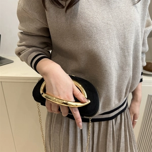 Chic black suede crossbody clutch bag with elegant gold U-shaped metal handle and chain