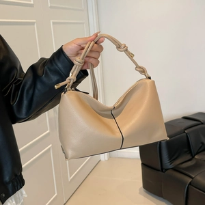 Chic beige lychee leather hobo bag with knotted shoulder strap and contrast stitching