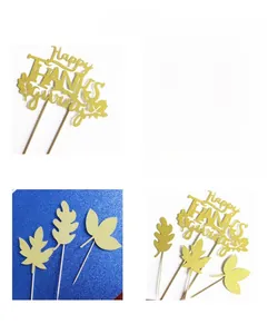 Detail view of gold glitter Happy Thanksgiving cake toppers with autumn maple leaf designs