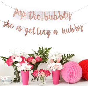 Rose gold glitter banner with Pop The Bubbly text for bridal shower decoration